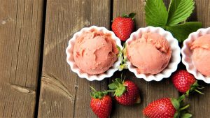 Imagen de un helado de fresa con fresas naturales